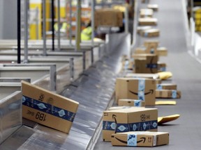 Amazon packages move along a conveyor at an Amazon warehouse facility in Goodyear, Ariz., Dec. 17, 2019.