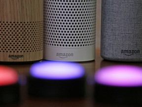 Amazon Echo and Echo Plus devices, behind, sit near illuminated Echo Button devices during an event announcing several new Amazon products by the company, Sept. 27, 2017, in Seattle.