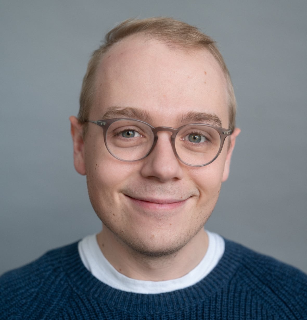 A man laughs at the camera
